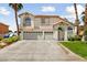 Two-story house with a three-car garage and landscaped yard at 1138 Aspen Valley Ave, Las Vegas, NV 89123