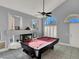 Game room with a pool table, fireplace, and large windows at 1138 Aspen Valley Ave, Las Vegas, NV 89123