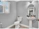 Neatly designed powder room with pedestal sink and toilet at 1138 Aspen Valley Ave, Las Vegas, NV 89123