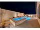 Night view of a beautiful backyard pool and spa at 11870 Star Grass Ave, Las Vegas, NV 89138