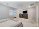 Bright bedroom with king bed, dresser, and neutral color palette at 11870 Star Grass Ave, Las Vegas, NV 89138