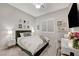 Bedroom with green velvet headboard and en-suite bathroom at 11870 Star Grass Ave, Las Vegas, NV 89138