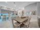 Open concept dining area with farmhouse table and chairs near kitchen at 11870 Star Grass Ave, Las Vegas, NV 89138