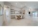 Open dining area with farmhouse table and chairs, built in shelving and large art piece at 11870 Star Grass Ave, Las Vegas, NV 89138