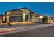 Two-car garage and inviting front entrance with landscaping at 11870 Star Grass Ave, Las Vegas, NV 89138