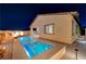 Night view of a resort-style backyard pool and spa at 11870 Star Grass Ave, Las Vegas, NV 89138