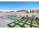 Modern backyard with a pool and patio furniture at 11870 Star Grass Ave, Las Vegas, NV 89138