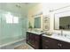 Elegant bathroom with double vanity, marble countertops, and a large shower at 1409 Denver St, Boulder City, NV 89005