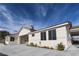 Single story home with light colored exterior and a covered entryway at 1409 Denver St, Boulder City, NV 89005