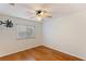 Bright bedroom with wood floors, ceiling fan, and window coverings at 1420 Ellen Tracy Way, Henderson, NV 89014