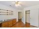 Home office with built-in shelving and hardwood floors at 1420 Ellen Tracy Way, Henderson, NV 89014