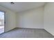 Bright bedroom with grey carpet and sliding glass door to backyard at 162 Windy Creek Ave, Las Vegas, NV 89123