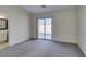 Bright bedroom with grey carpet and sliding glass door to backyard at 162 Windy Creek Ave, Las Vegas, NV 89123