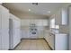 Kitchen with white cabinets, gas range and refrigerator at 162 Windy Creek Ave, Las Vegas, NV 89123