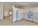 Kitchen with white appliances and view into living room at 162 Windy Creek Ave, Las Vegas, NV 89123