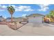 Single-story house with a two-car garage and landscaped front yard at 1627 Candice St, Las Vegas, NV 89156