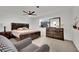 Main bedroom with king bed, dresser, and ceiling fan at 1627 Candice St, Las Vegas, NV 89156