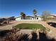 Large backyard with artificial turf and palm trees at 1761 Augusta St, Pahrump, NV 89048