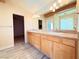 Bathroom with double sinks and light wood cabinets at 1761 Augusta St, Pahrump, NV 89048