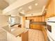 Bright kitchen with wood cabinets, granite counters, and island at 1761 Augusta St, Pahrump, NV 89048