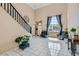 Bright entryway with high ceilings, tile flooring, and a staircase at 2108 Royal Antilles Ct, North Las Vegas, NV 89031