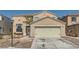 Two-story house with beige exterior, attached garage, and landscaping at 2108 Royal Antilles Ct, North Las Vegas, NV 89031