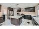 Modern kitchen with dark cabinetry, quartz countertops, and island at 2108 Royal Antilles Ct, North Las Vegas, NV 89031