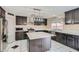 Modern kitchen with dark cabinetry, quartz countertops, and island at 2108 Royal Antilles Ct, North Las Vegas, NV 89031