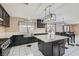 Modern kitchen with dark cabinetry, quartz countertops, and island at 2108 Royal Antilles Ct, North Las Vegas, NV 89031