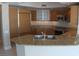 Modern kitchen with wood cabinets and granite counters at 222 Karen Ave # 2708, Las Vegas, NV 89109