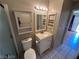 Bright bathroom featuring a white vanity and mirrored medicine cabinet at 2235 High Dunes Ln, Laughlin, NV 89029