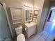 Efficient bathroom with a vanity, toilet, medicine cabinet and open shelving to optimize storage space at 2235 High Dunes Ln, Laughlin, NV 89029
