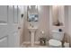 Small bathroom with pedestal sink, toilet, and decorative accents at 2469 Sun Reef Rd, Las Vegas, NV 89128