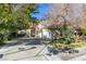 Two-story home with a large driveway and mature trees at 2469 Sun Reef Rd, Las Vegas, NV 89128