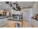 Spacious kitchen with island, granite countertops and a pot rack at 2469 Sun Reef Rd, Las Vegas, NV 89128