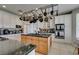 Updated kitchen featuring granite island and pot rack at 2469 Sun Reef Rd, Las Vegas, NV 89128