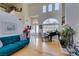 Bright living area featuring hardwood floors, large windows, and a grand piano at 2469 Sun Reef Rd, Las Vegas, NV 89128