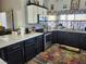 Modern kitchen with dark cabinetry, quartz countertops, and stainless steel appliances at 2651 Homestead Rd, Pahrump, NV 89048