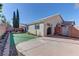 Artificial turf backyard with raised garden beds and storage shed at 2693 Hollowvale Ln, Henderson, NV 89052