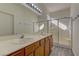 Double vanity bathroom with a large shower and tile floor at 2693 Hollowvale Ln, Henderson, NV 89052