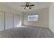 Bright bedroom featuring ceiling fan and ample closet space at 2693 Hollowvale Ln, Henderson, NV 89052