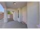 Covered front porch with pink door and white railing at 2693 Hollowvale Ln, Henderson, NV 89052