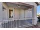 Covered entry porch with pink door and a small sitting area at 2693 Hollowvale Ln, Henderson, NV 89052