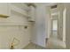 Laundry room with shelving and access to hallway at 2693 Hollowvale Ln, Henderson, NV 89052