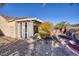 Landscaped backyard with a covered patio and pathway at 2707 White Sage Dr, Henderson, NV 89052