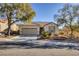 Single-story house with a two-car garage and landscaped front yard at 2707 White Sage Dr, Henderson, NV 89052