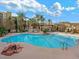 Resort-style pool with palm trees and a fire pit at 30 Strada Di Villaggio # 339, Henderson, NV 89011