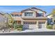 Two-story house with beige exterior, three-car garage, and landscaped front yard at 3065 Lenoir St, Las Vegas, NV 89135