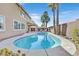 Inviting kidney-shaped pool with a patio and palm trees in the backyard at 3065 Lenoir St, Las Vegas, NV 89135