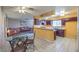 Eat-in kitchen with dark wood cabinets and view of living room at 3091 Liberty Cir, Las Vegas, NV 89121